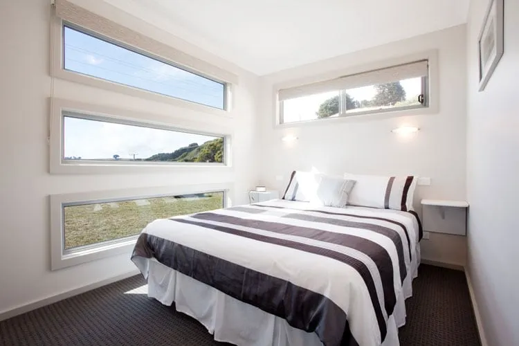 Main bedroom with queen bed and bay views